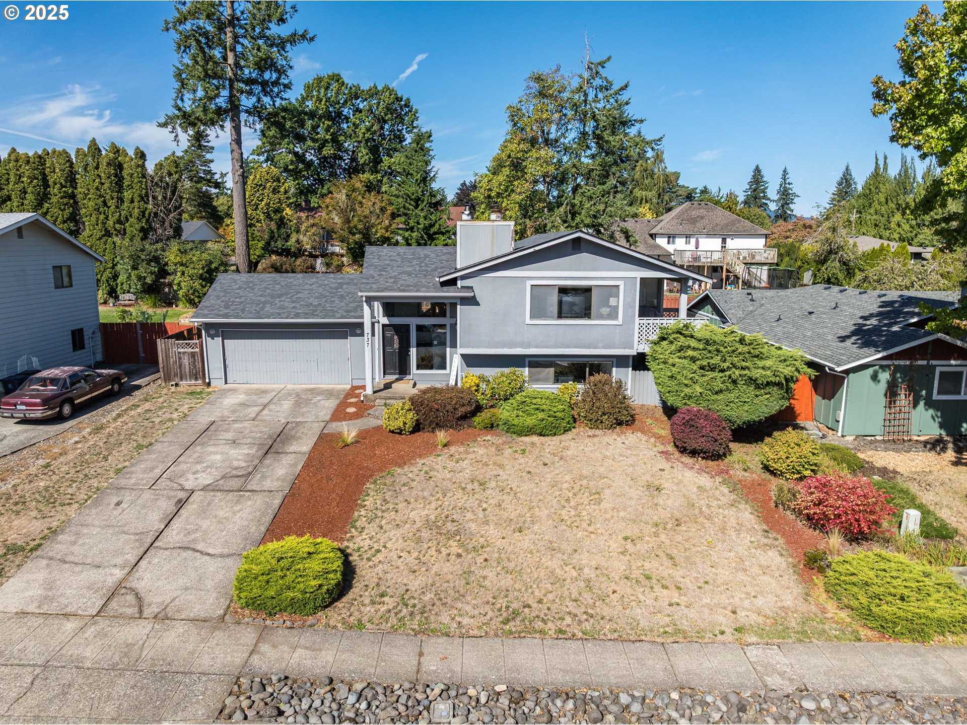737 Northwest 20th Avenue Camas, WA 98607 - Photo 37 of 40 a white house with a large tree in front of it