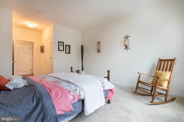 a bedroom with a bed and a chair