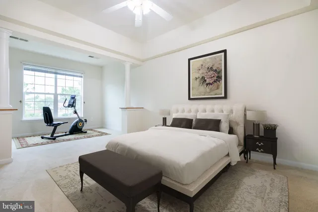 a bedroom with a bed a table and chair