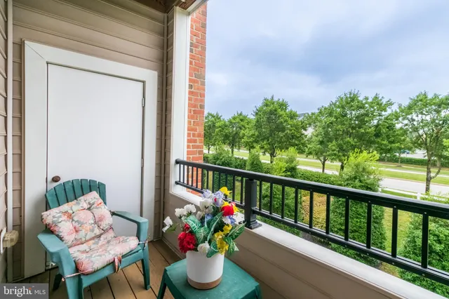 a view of a porch with furniture and a potted plant