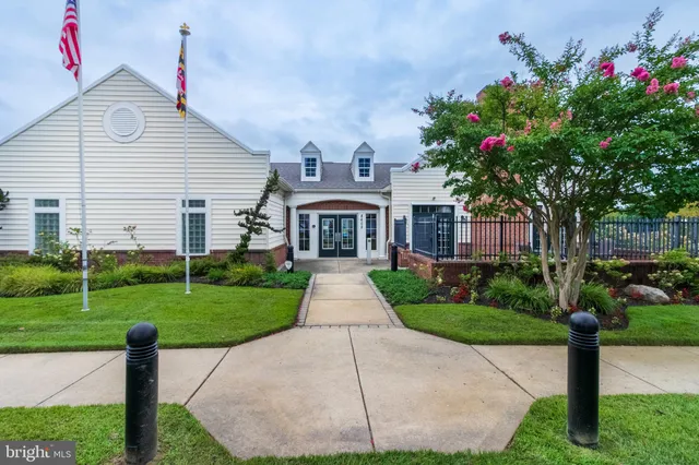 a front view of a house with a yard and a garden