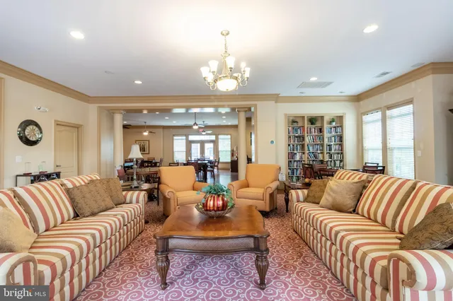 a living room with furniture chandelier and couch