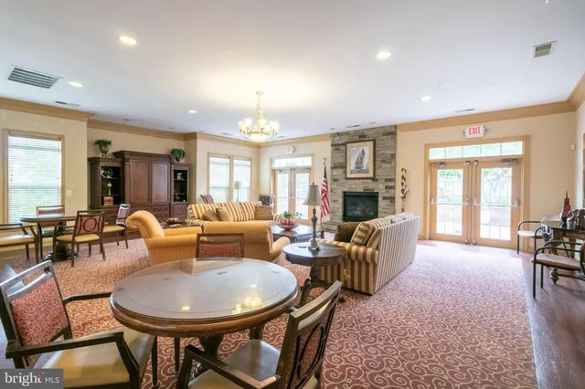 a living room with furniture a flat screen tv and kitchen view