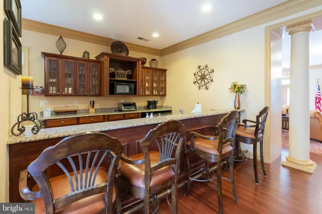 a view of a dining room with furniture and wooden floor