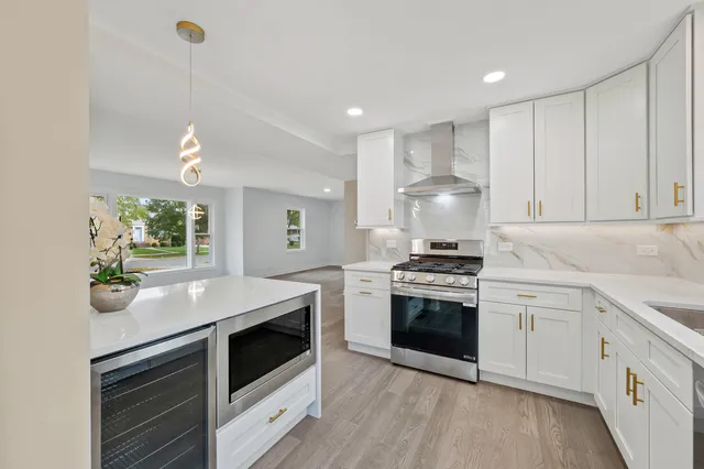 a kitchen with a stove and white cabinets