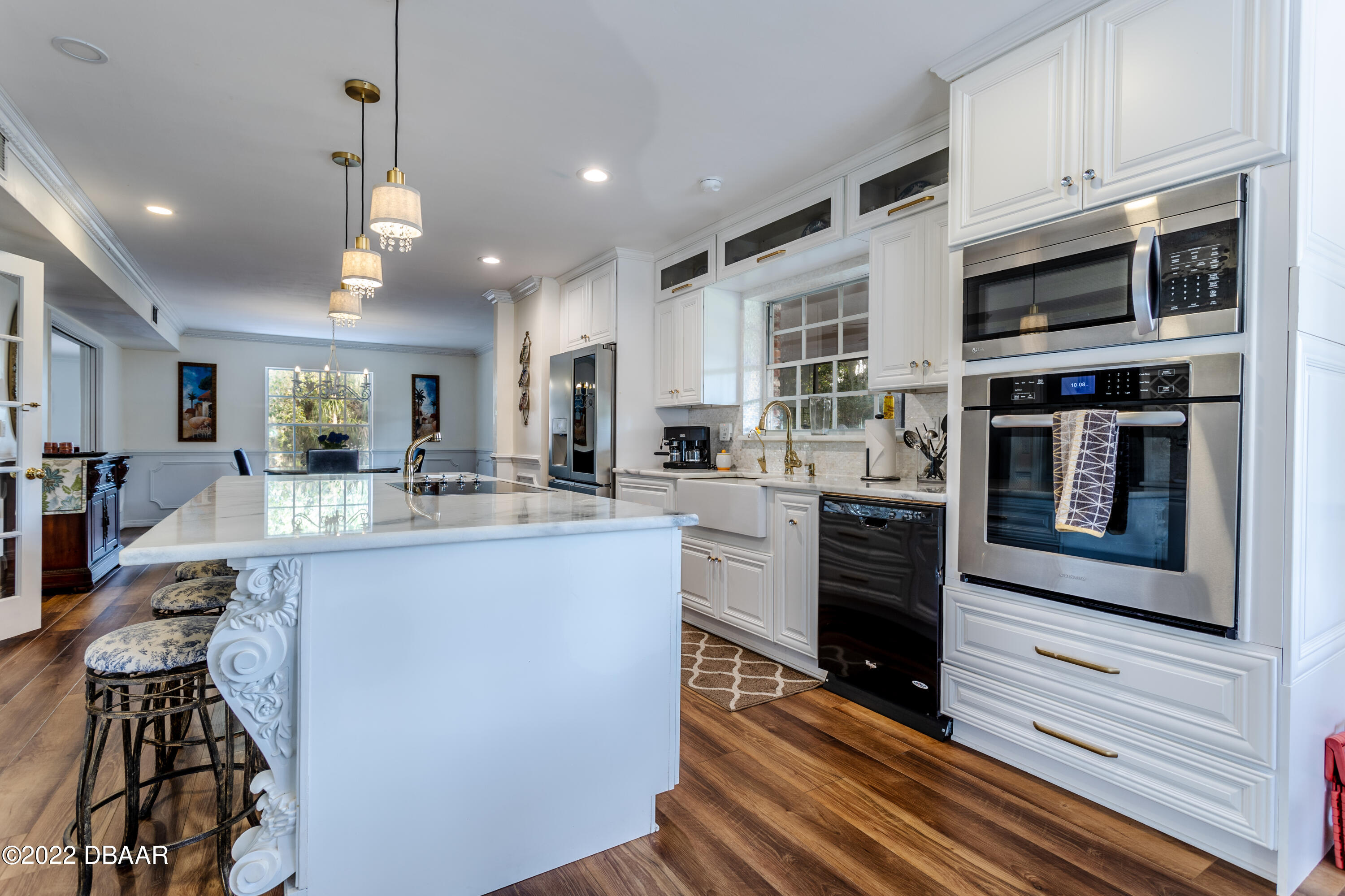 82 North St Andrews Drive Ormond Beach, FL 32174 - Photo 14 of 60 a kitchen with stainless steel appliances kitchen island granite countertop a stove and cabinets