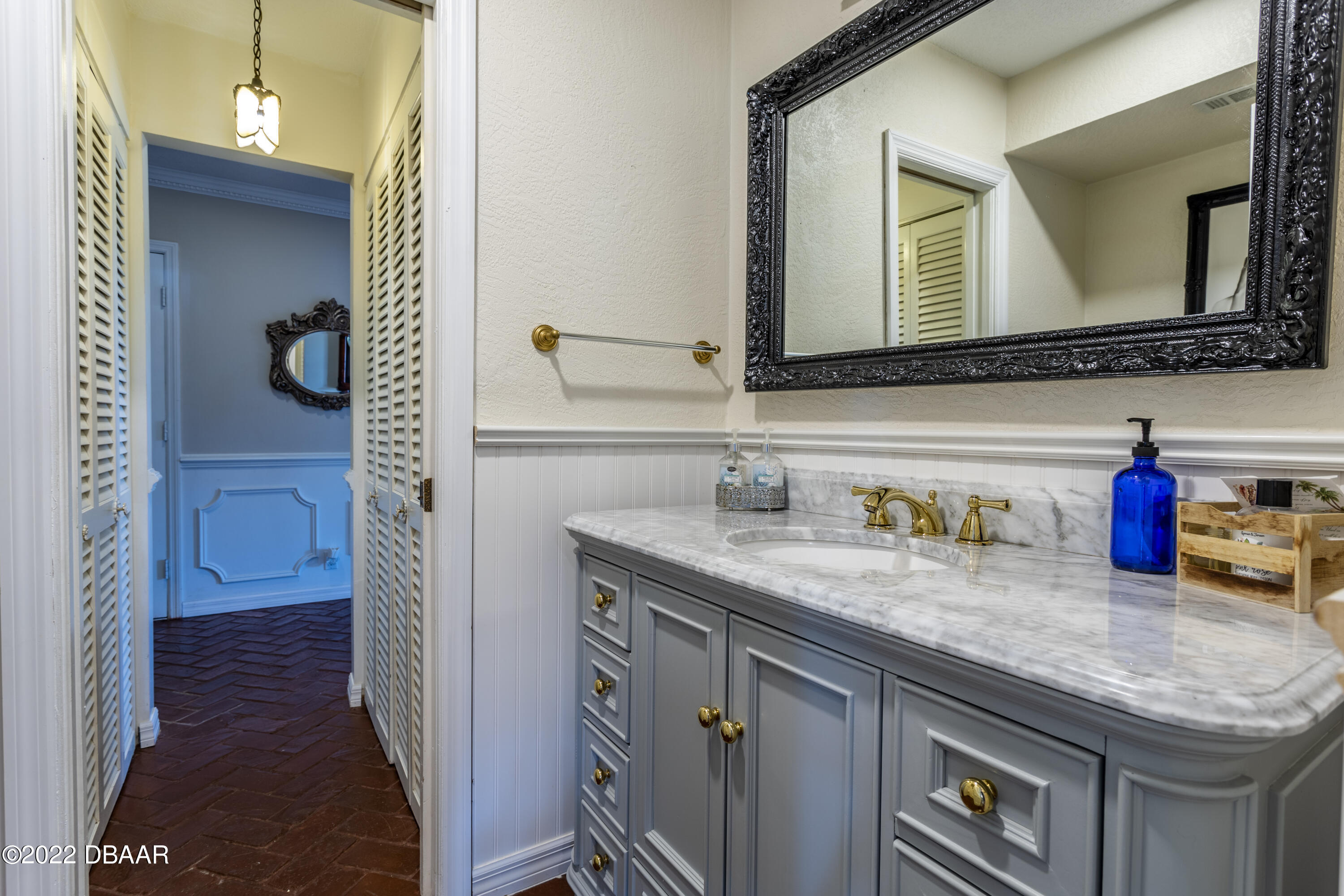 82 North St Andrews Drive Ormond Beach, FL 32174 - Photo 21 of 60 a bathroom with a granite countertop sink and a mirror