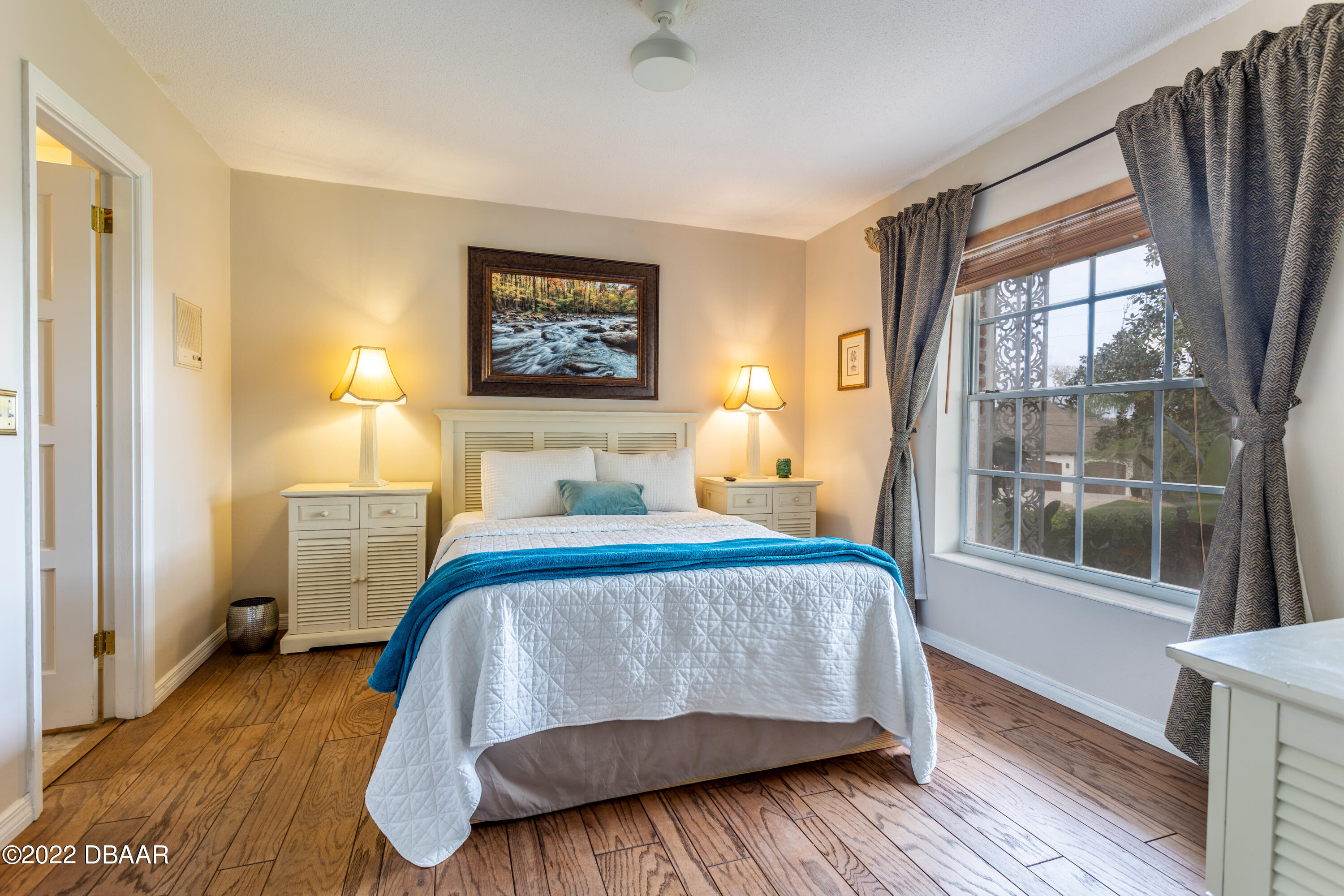 82 North St Andrews Drive Ormond Beach, FL 32174 - Photo 22 of 60 a bedroom with a bed and wooden floor