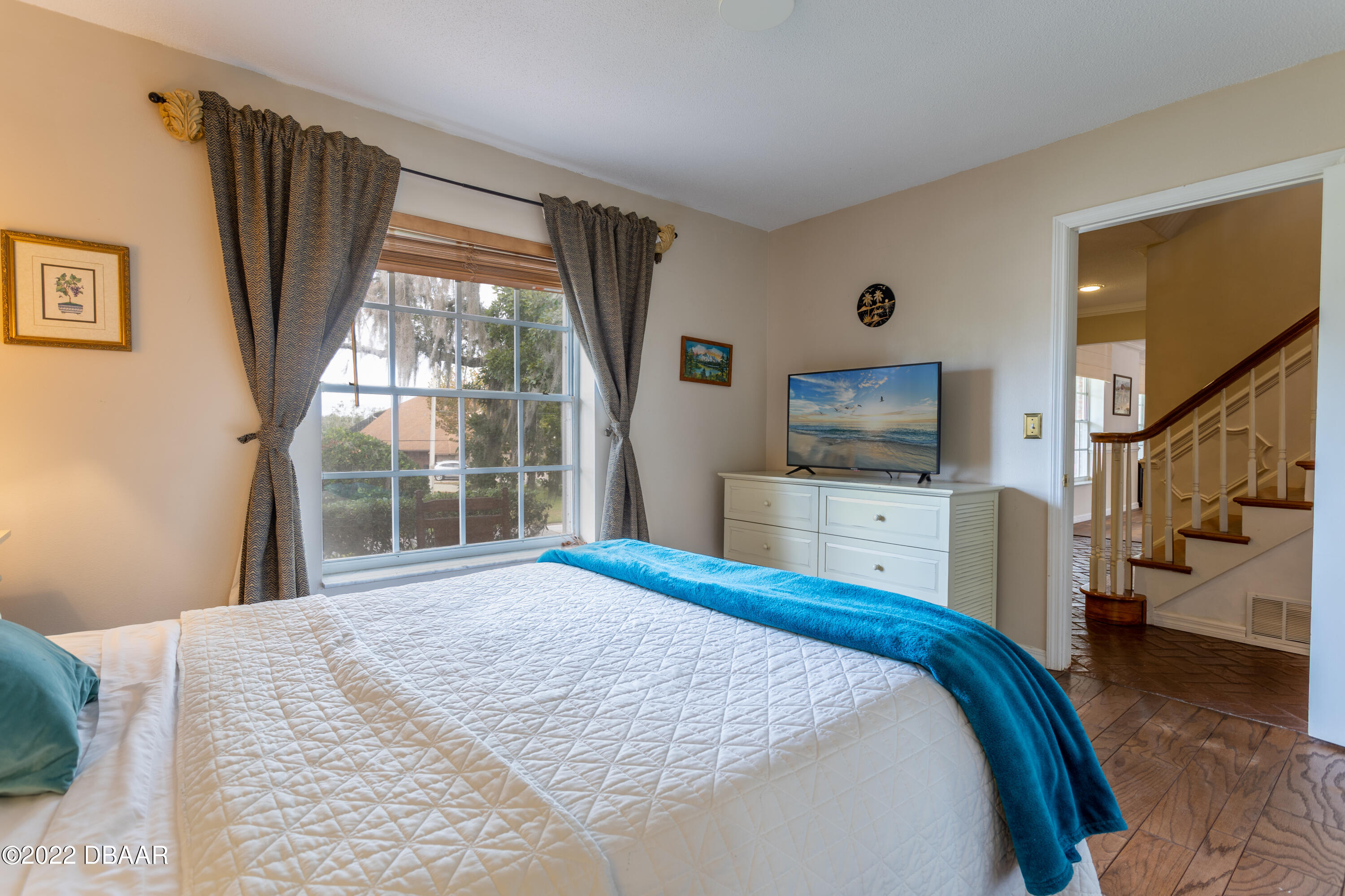 82 North St Andrews Drive Ormond Beach, FL 32174 - Photo 23 of 60 a bedroom with a bed and a flat tv screen on dresser