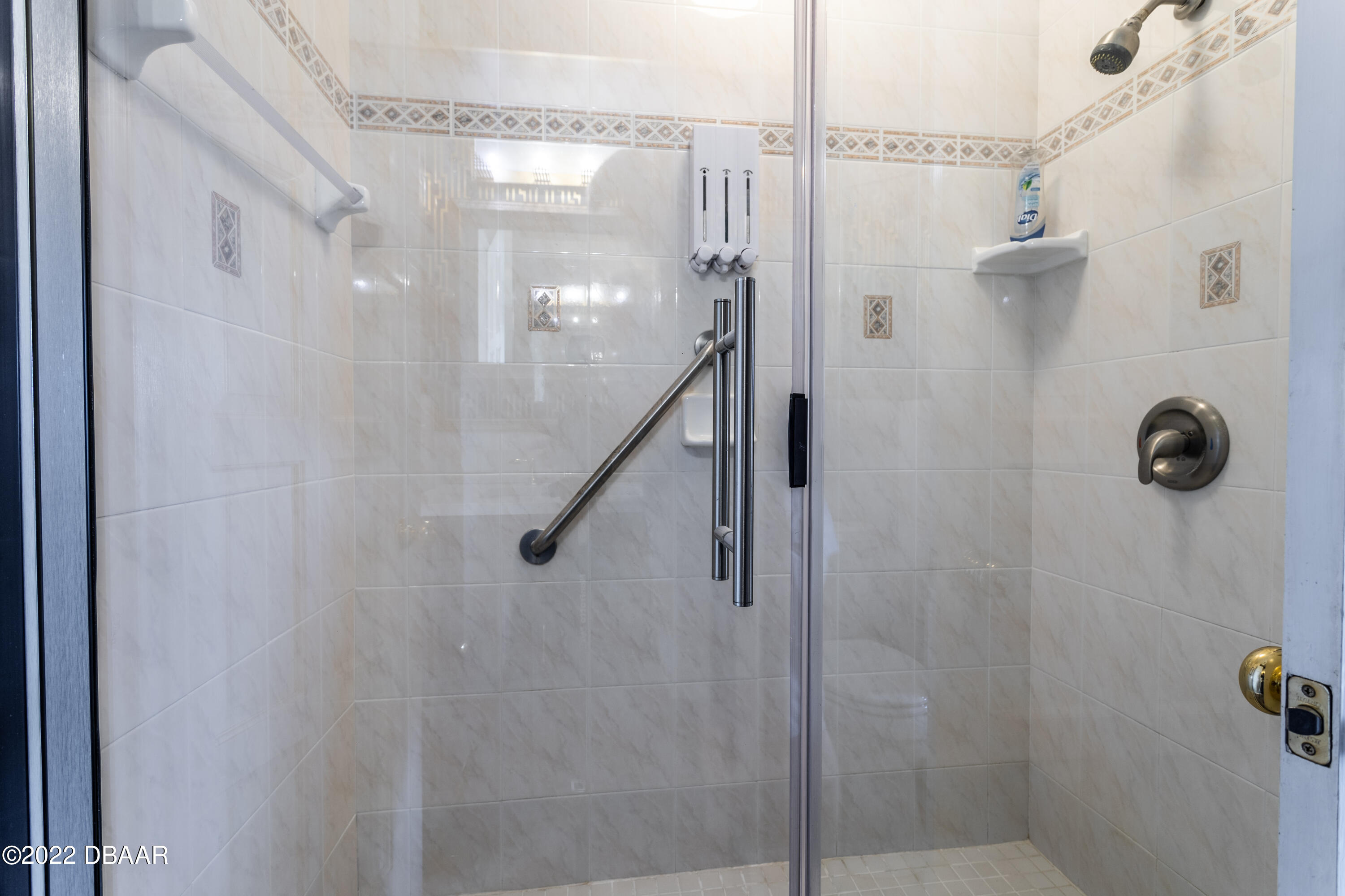 82 North St Andrews Drive Ormond Beach, FL 32174 - Photo 25 of 60 a bathroom with a glass shower door