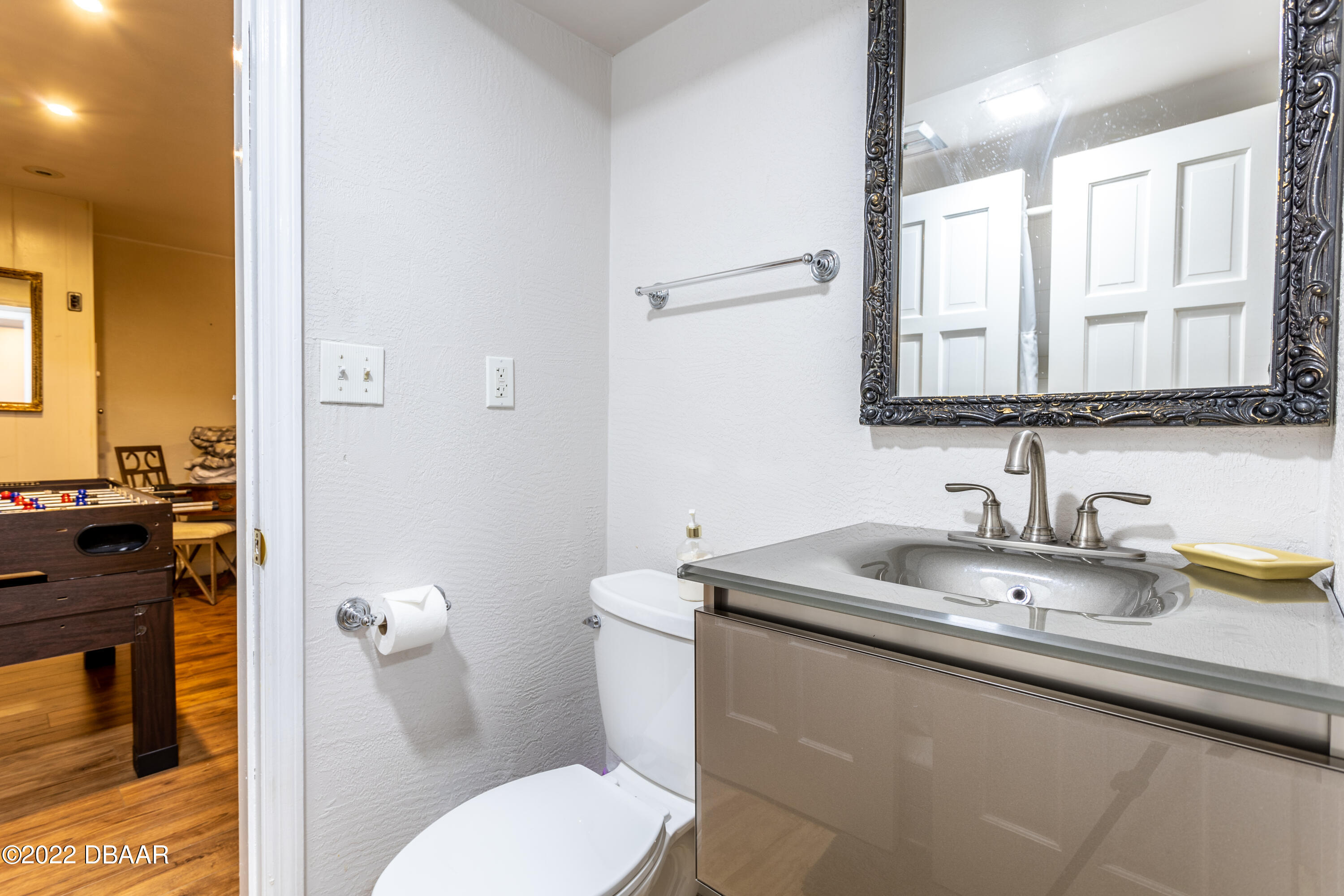 82 North St Andrews Drive Ormond Beach, FL 32174 - Photo 30 of 60 a bathroom with a granite countertop toilet sink and mirror