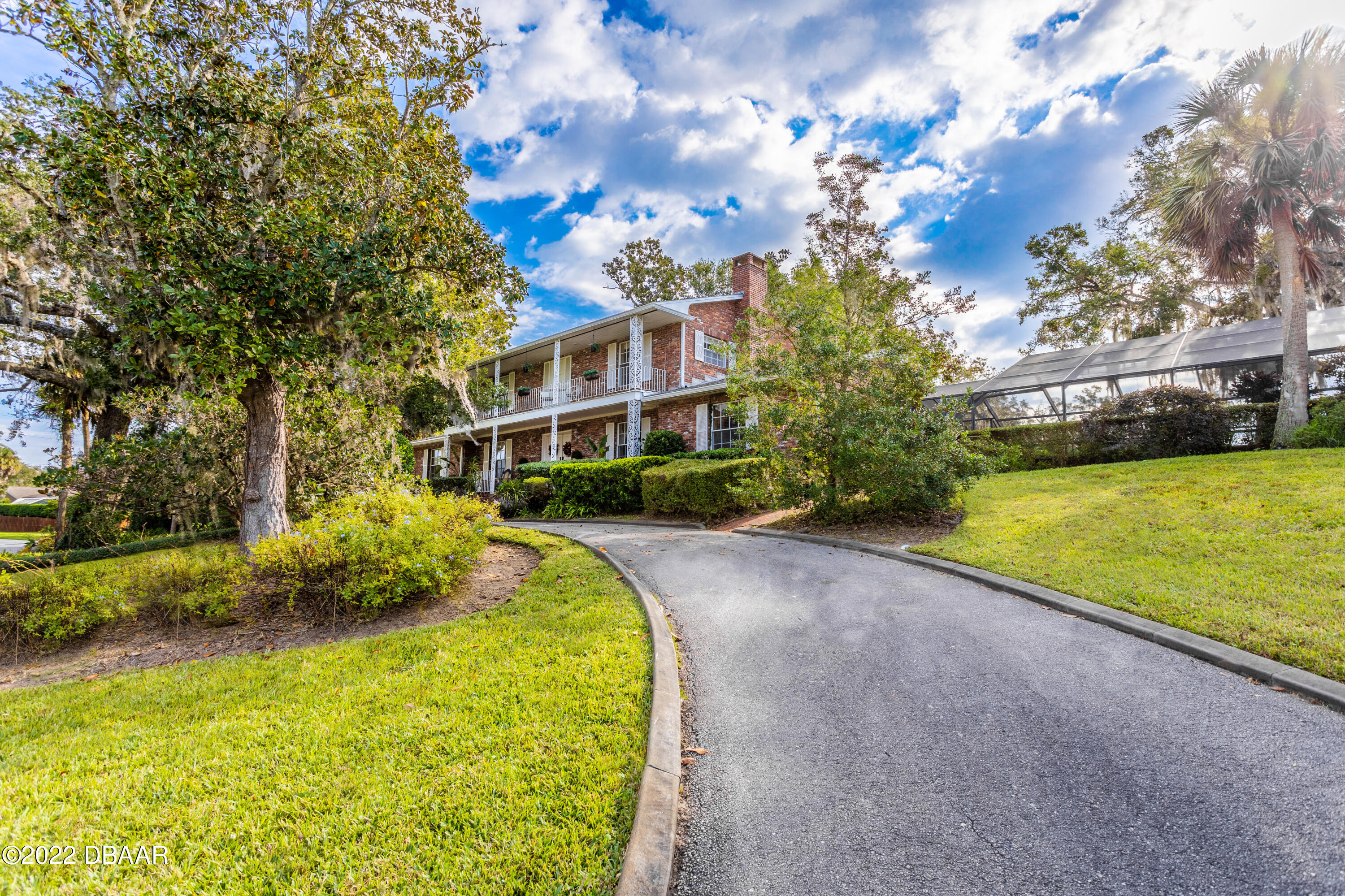 82 North St Andrews Drive Ormond Beach, FL 32174 - Photo 3 of 60 a swimming pool with outdoor seating and yard