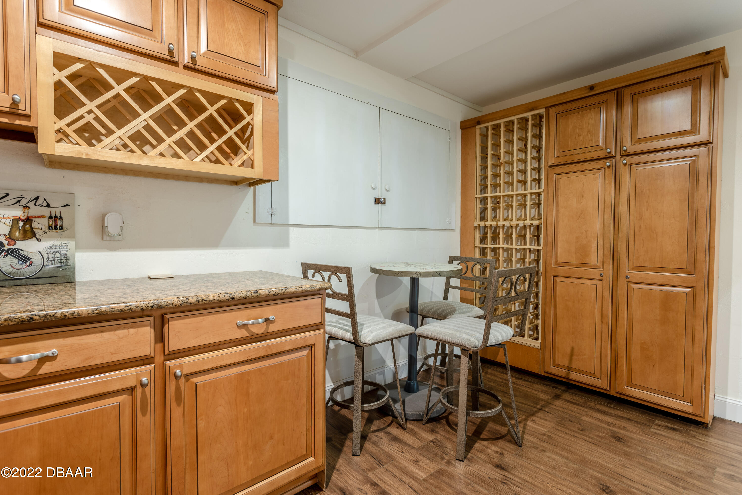 82 North St Andrews Drive Ormond Beach, FL 32174 - Photo 33 of 60 a kitchen with stainless steel appliances granite countertop a stove a sink and a refrigerator with wooden floors