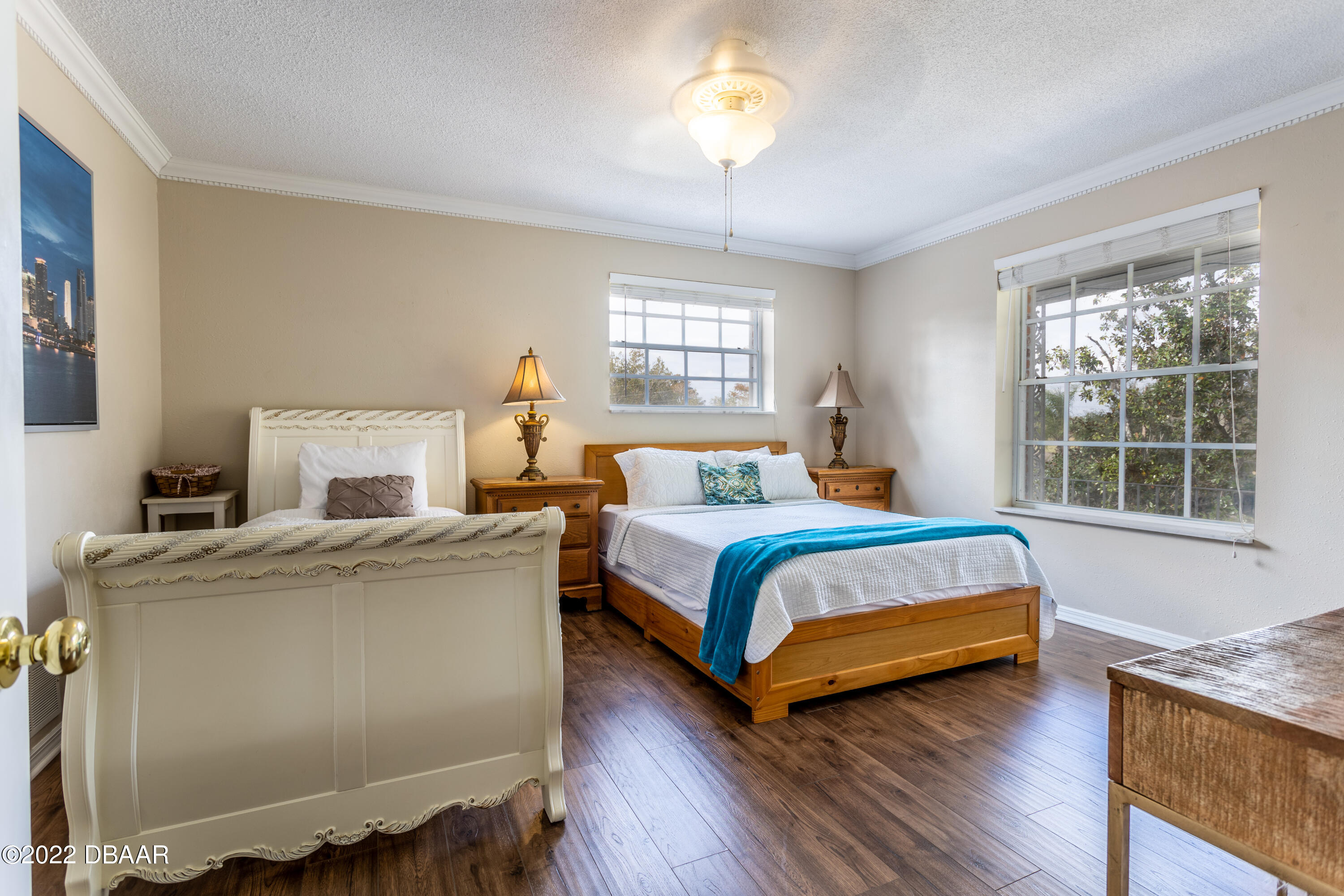 82 North St Andrews Drive Ormond Beach, FL 32174 - Photo 35 of 60 a bedroom with a bed and a chandelier