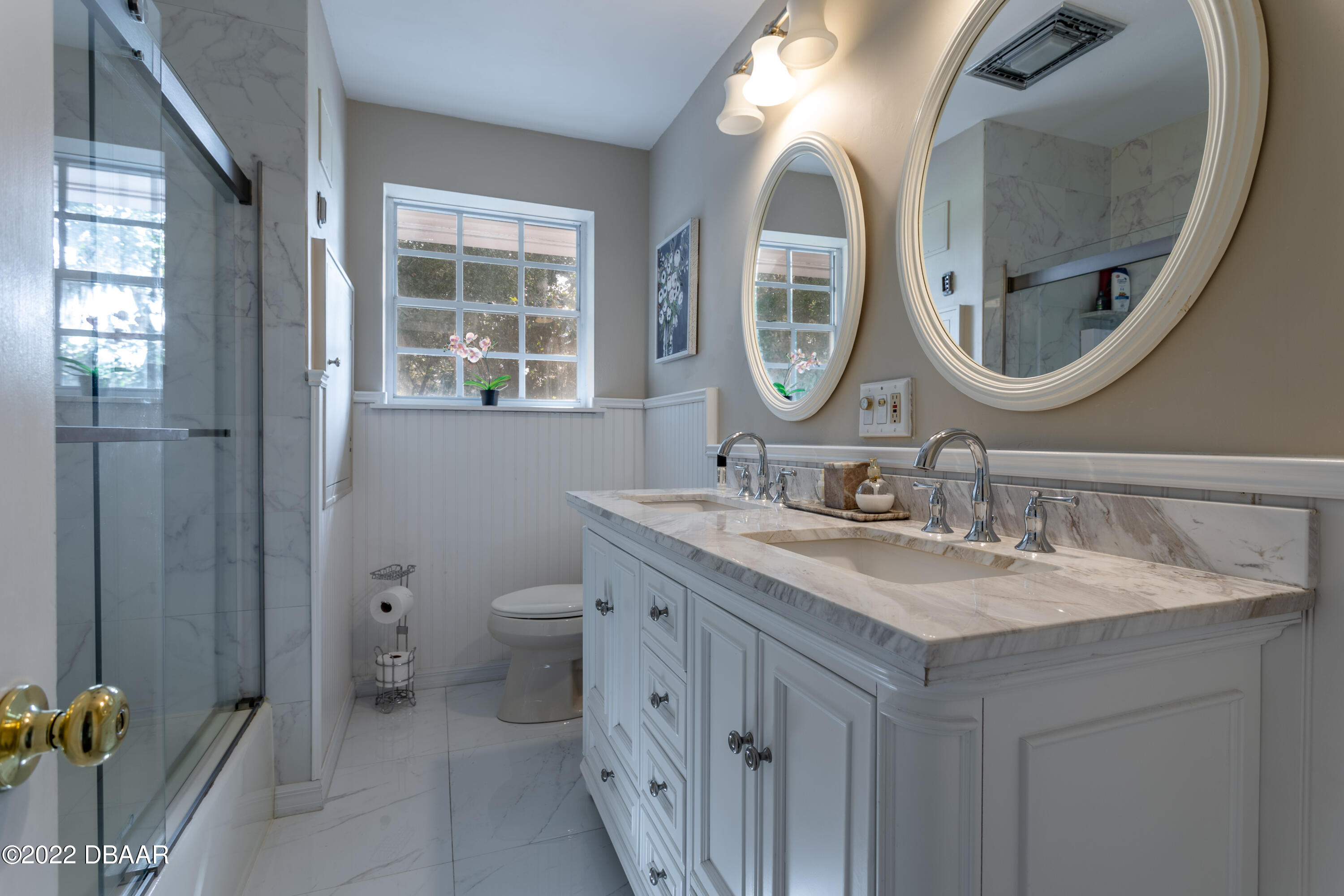 82 North St Andrews Drive Ormond Beach, FL 32174 - Photo 42 of 60 a bathroom with a granite countertop toilet a sink and a mirror