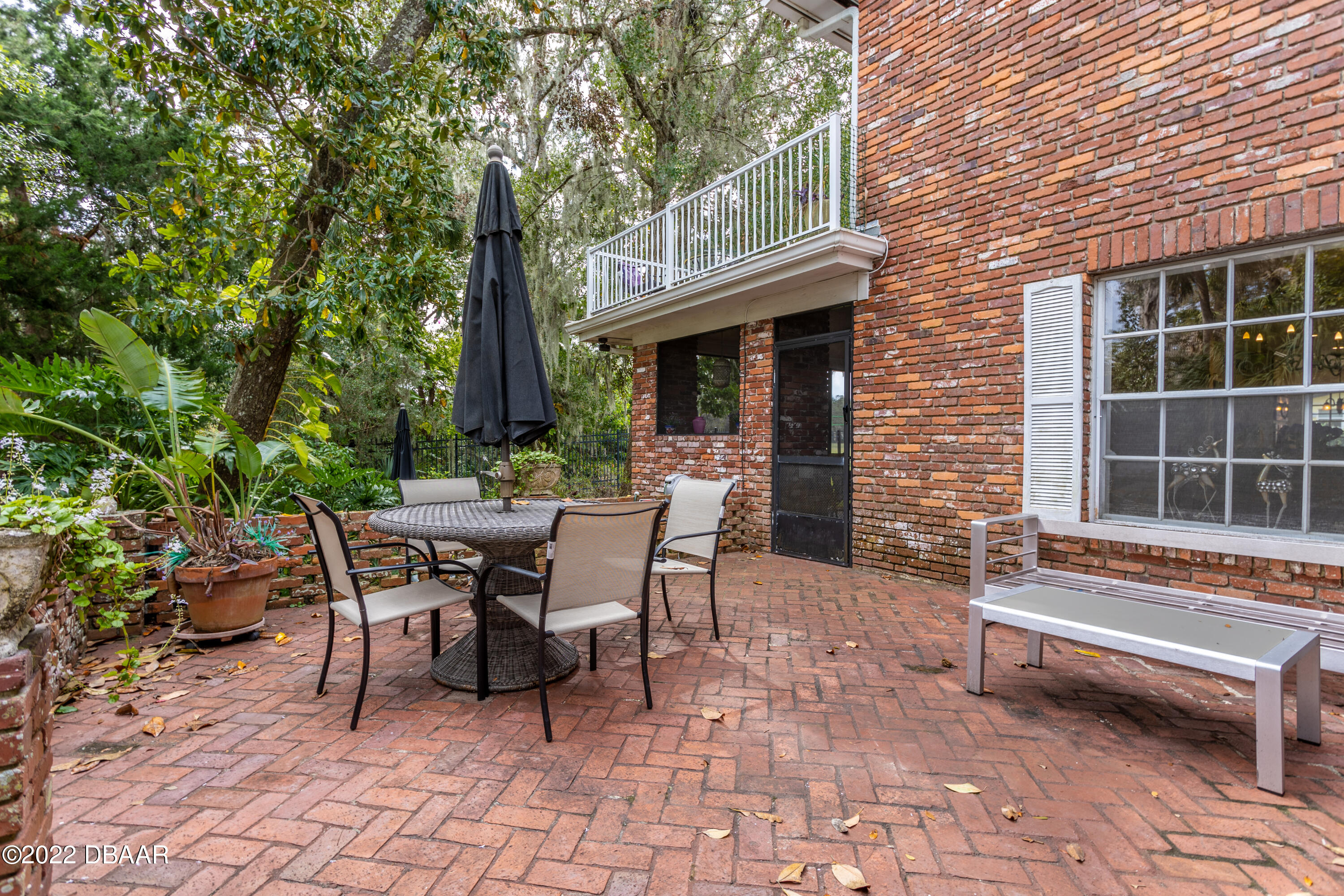 82 North St Andrews Drive Ormond Beach, FL 32174 - Photo 54 of 60 a view of a patio with a table and chairs