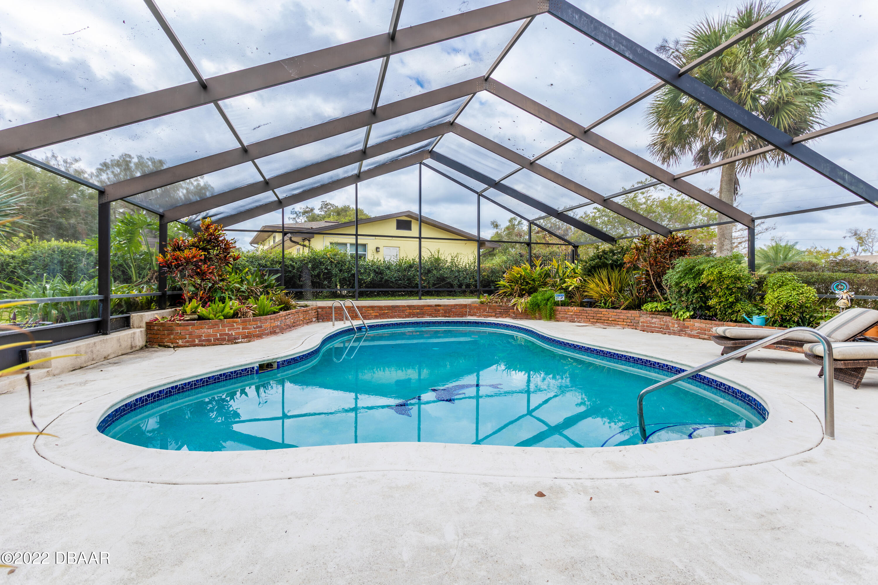 82 North St Andrews Drive Ormond Beach, FL 32174 - Photo 57 of 60 a view of a swimming pool with a patio