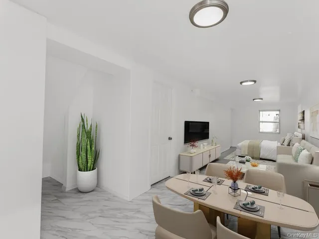 a living room with furniture a window and a potted plant