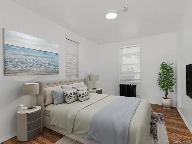 a bedroom with a bed and a potted plant