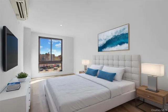 a bedroom with a bed and a flat screen tv