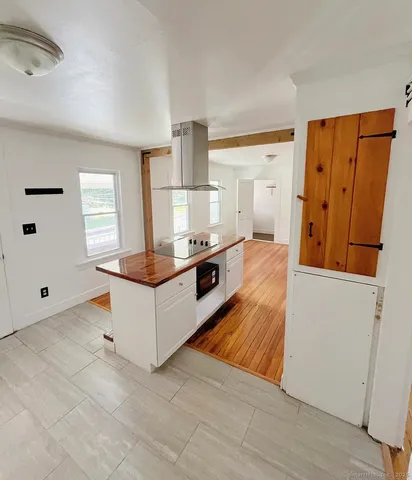 a living room with stainless steel appliances kitchen island granite countertop furniture and a window