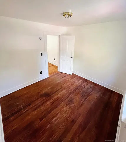 a view of room with wooden floor