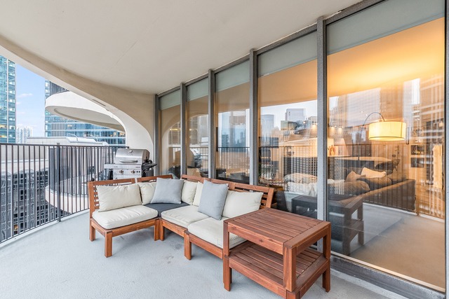 300 North State Street, Unit 2512 Chicago, IL 60654 - Photo 14 of 17 a living room with furniture and a floor to ceiling window