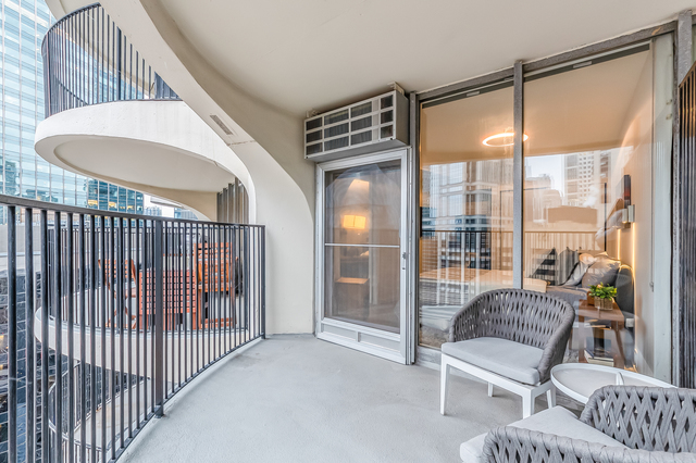 300 North State Street, Unit 2512 Chicago, IL 60654 - Photo 15 of 17 a view of a porch with furniture and a floor to ceiling window