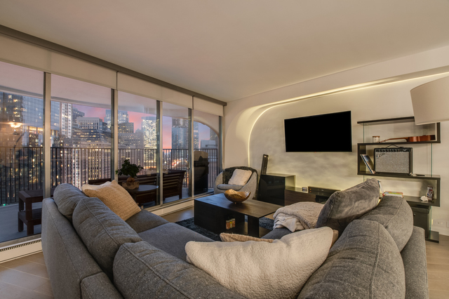 300 North State Street, Unit 2512 Chicago, IL 60654 - Photo 3 of 17 a living room with furniture a flat screen tv and a floor to ceiling window