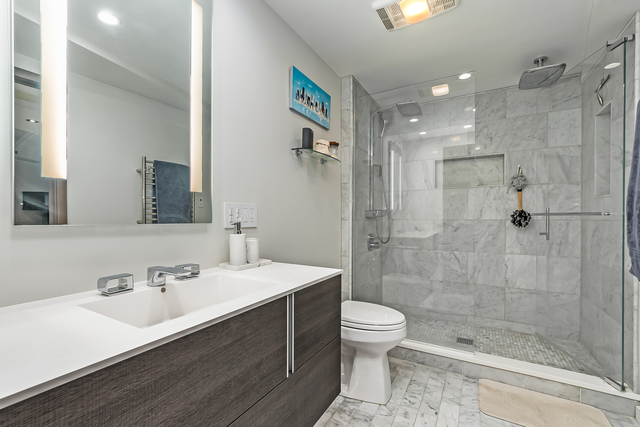 300 North State Street, Unit 2512 Chicago, IL 60654 - Photo 10 of 17 a bathroom with a sink a toilet and shower