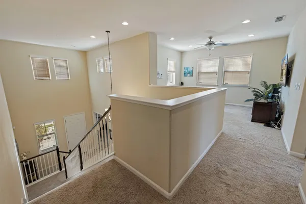 a spacious bedroom with a bed a table and large windows