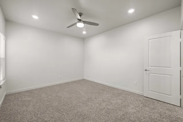 a spacious bathroom with a granite countertop sink a mirror and a shower