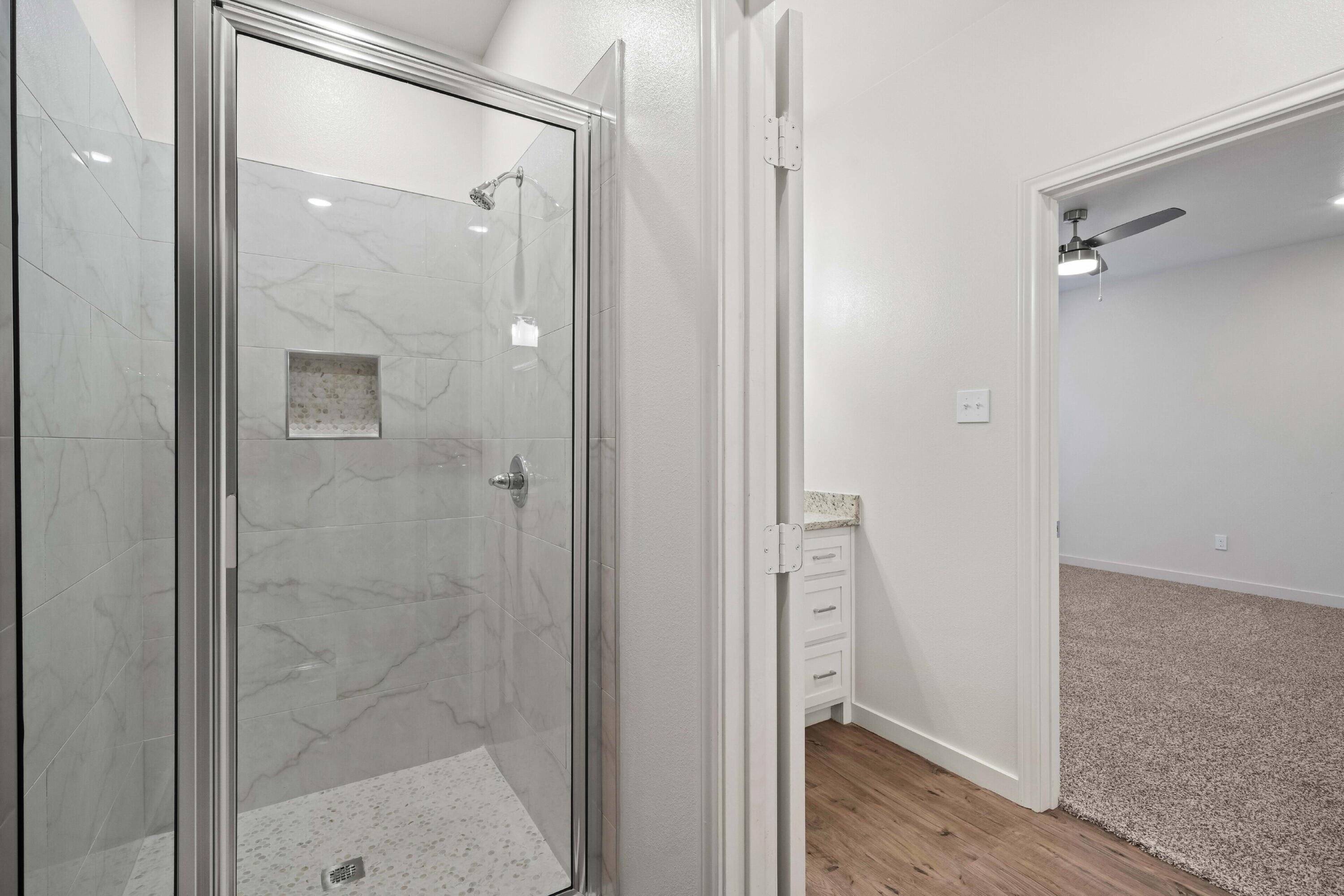 7014 40th Street, Unit A Lubbock, TX 79407 - Photo 16 of 19 a bathroom with a glass shower door
