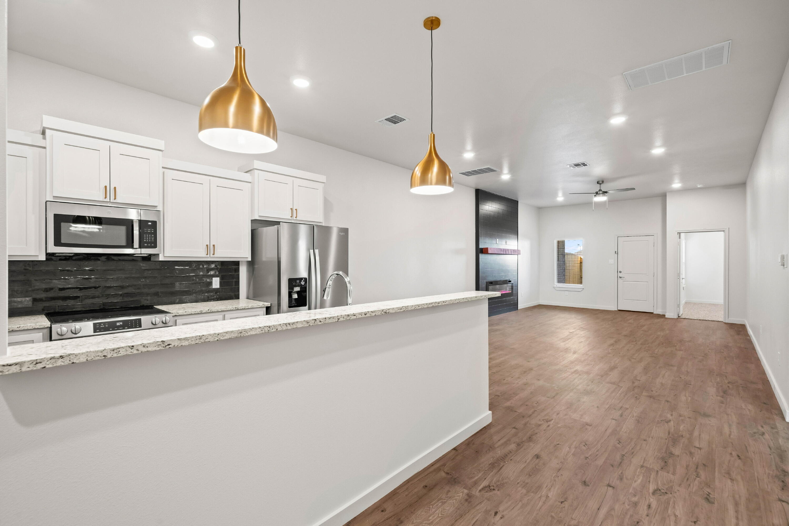7014 40th Street, Unit A Lubbock, TX 79407 - Photo 5 of 19 a view of a kitchen with a sink and a stove top oven