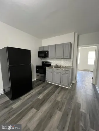 a view of a kitchen with a sink microwave and refrigerator