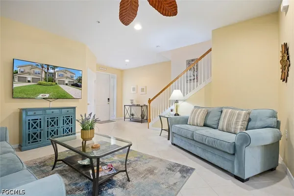 a living room with furniture and painting on the wall