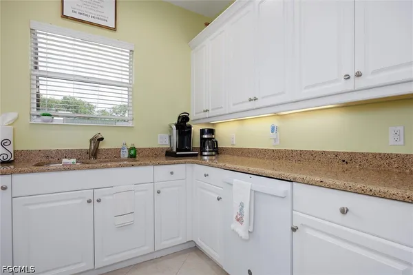 a living room with furniture rug and a chandelier