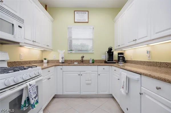 a backyard of a house with lots of green space and lake view