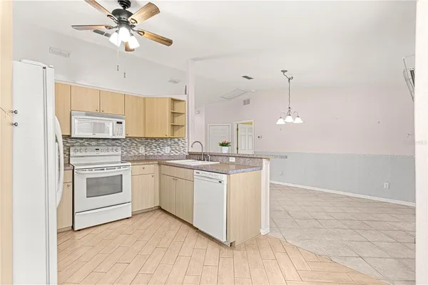 a kitchen with a sink cabinets and window