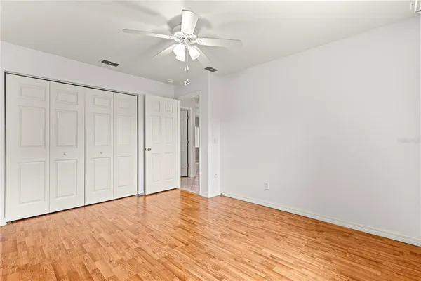 a view of empty room with wooden floor