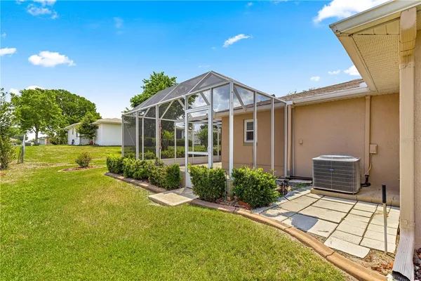 a view of a house with backyard and sitting area