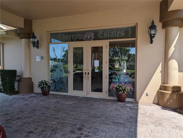 a lobby with furniture and chandelier