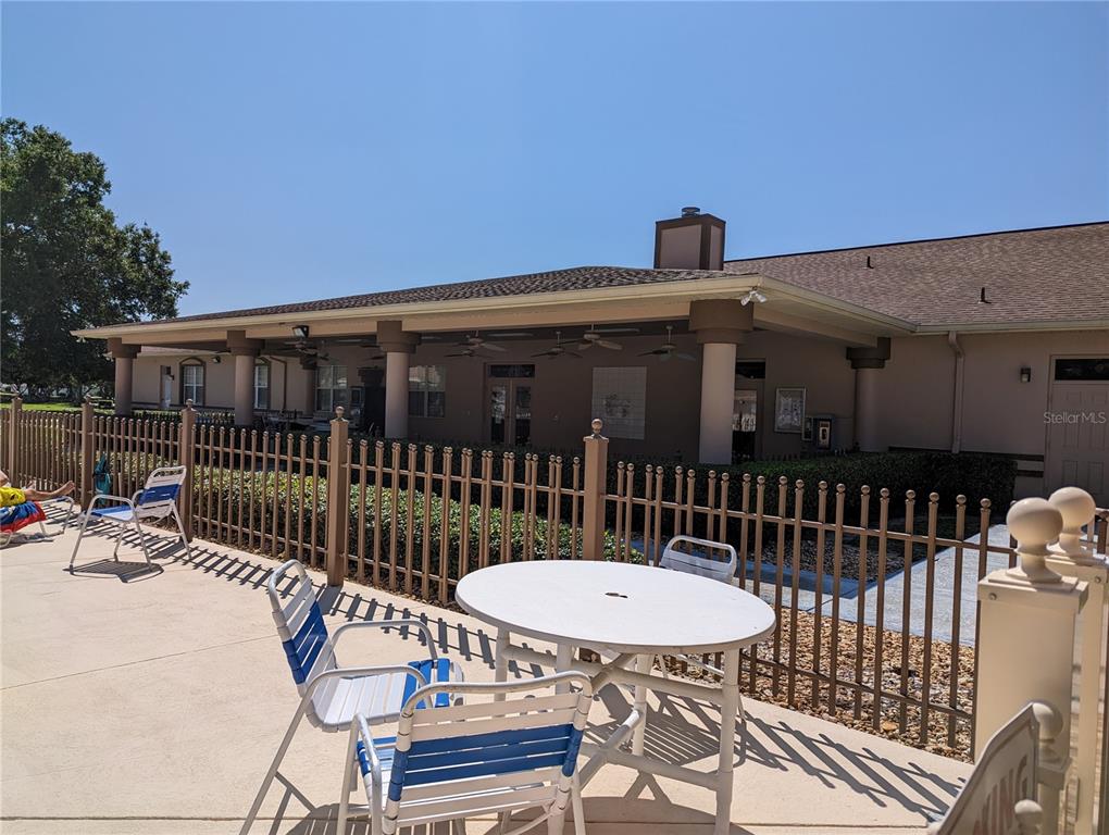 9958 Southwest 59th Circle Ocala, FL 34476 - Photo 44 of 45 a view of a roof deck with table and chairs a barbeque