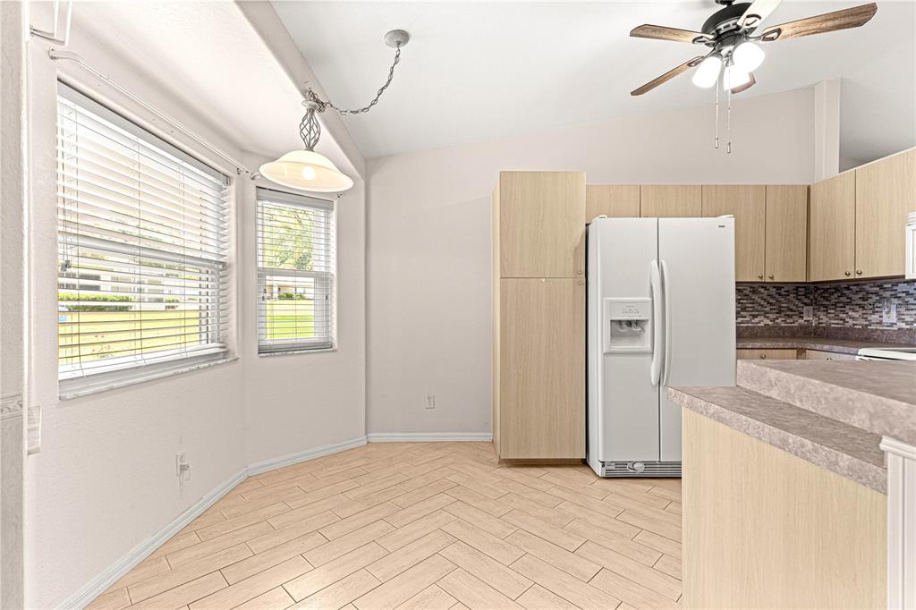 9958 Southwest 59th Circle Ocala, FL 34476 - Photo 10 of 45 a kitchen with stainless steel appliances a refrigerator and a chandelier