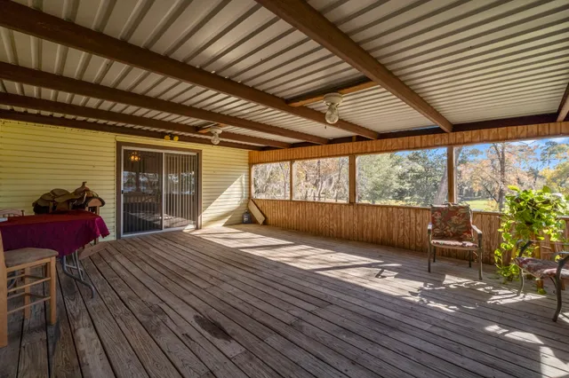 a view of a porch with wooden floor and fence