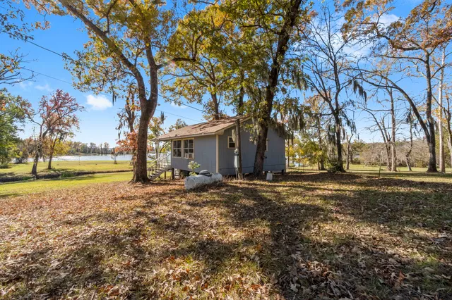 a living room with furniture kitchen view and a window