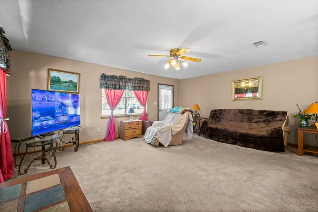 a bedroom with furniture and a flat screen tv