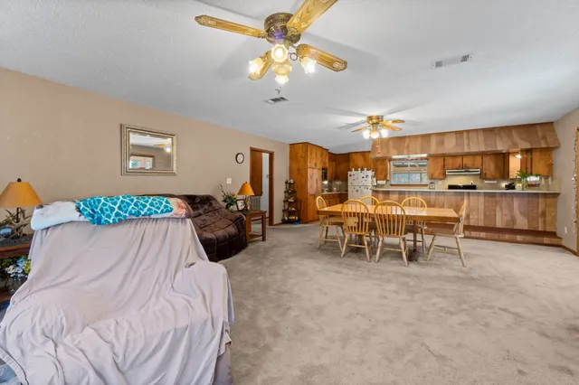 a dining room with furniture and chandelier