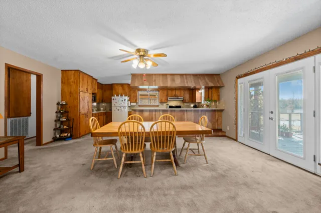 a view of a dining room with furniture and a chandelier