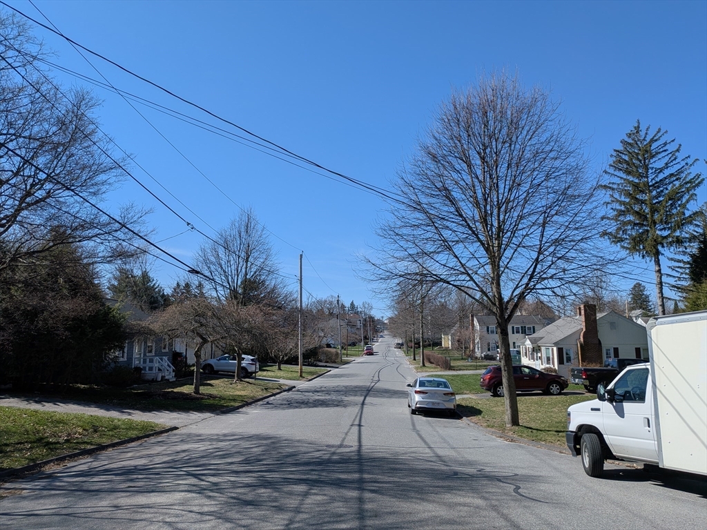 78 Leeds Street Worcester, MA 01606 - Photo 15 of 15 a view of road with card parked on side and retail shops